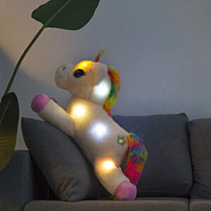 PELUCHE LICORNE ROSE LUMINEUSE SUR UN CANAPÉ