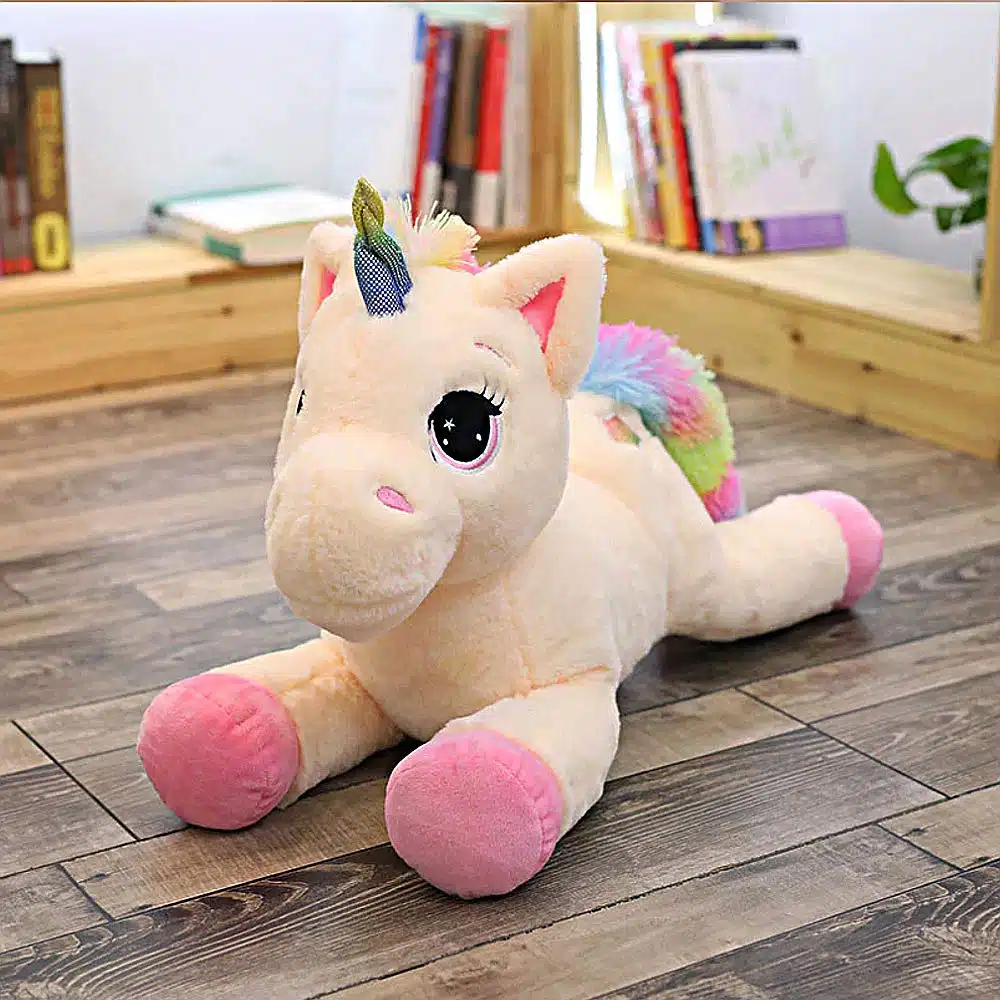 PELUCHE LICORNE ROSE SUR UN PARQUET